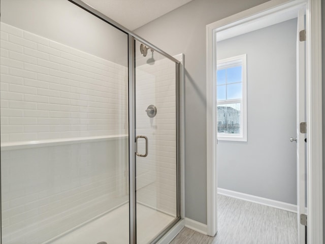 bathroom with a shower with door