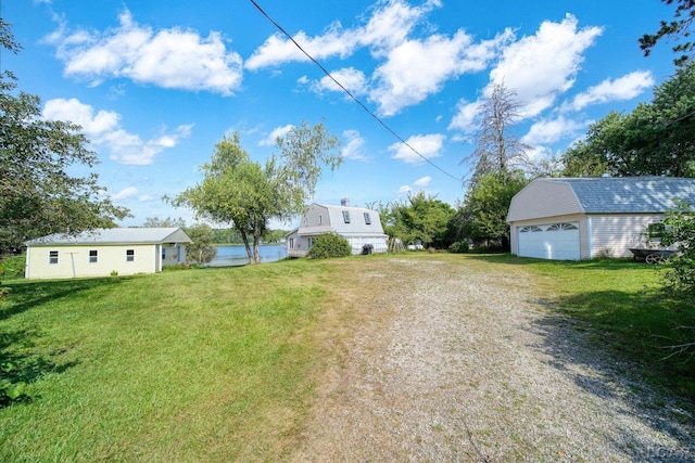 view of yard featuring an outbuilding and a garage