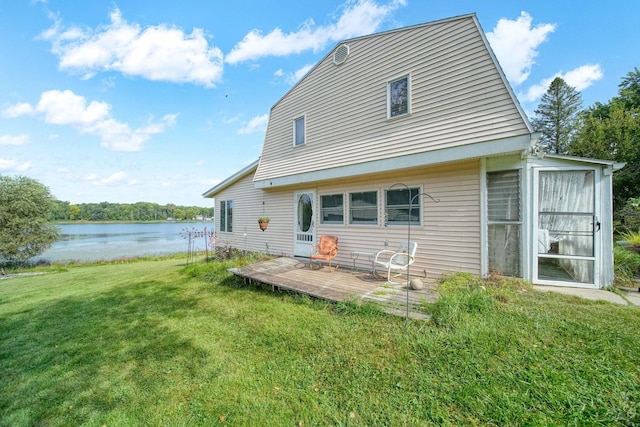 rear view of property featuring a yard and a water view