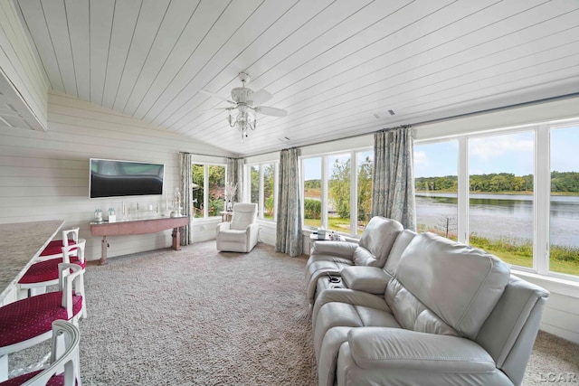 sunroom / solarium featuring a water view, vaulted ceiling, a wealth of natural light, and ceiling fan