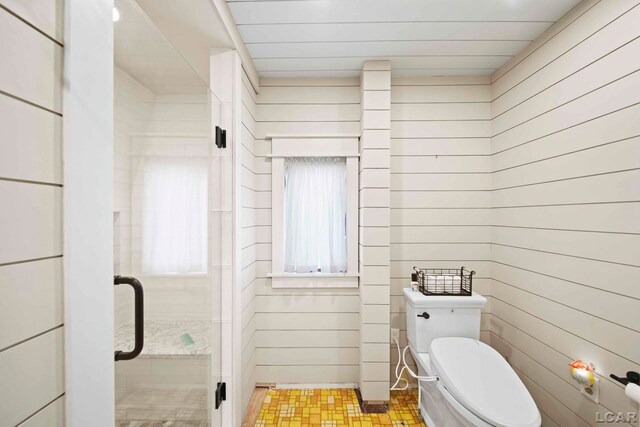 624 Fishermans Wharf, Horton, MI 49246 - bathroom with toilet, a shower stall, and wood walls