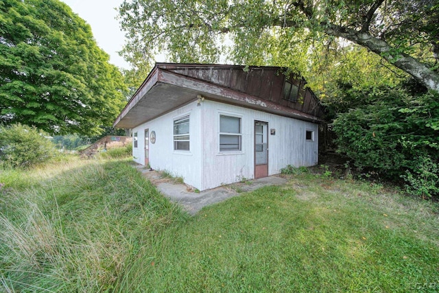 view of outdoor structure with a lawn