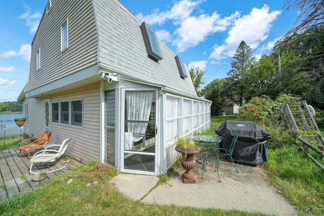 view of side of home featuring a wooden deck