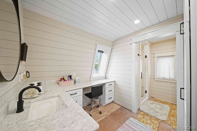 office with a wealth of natural light, wooden walls, and sink