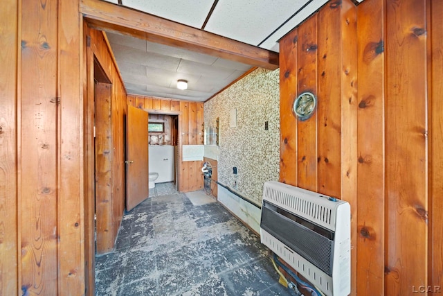 hallway with heating unit and wooden walls