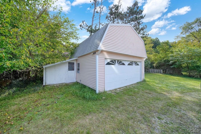 garage featuring a lawn