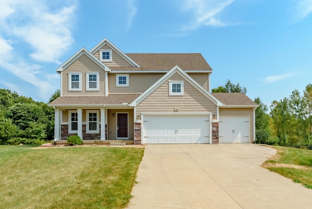 craftsman-style house with covered porch, a garage, and a front lawn