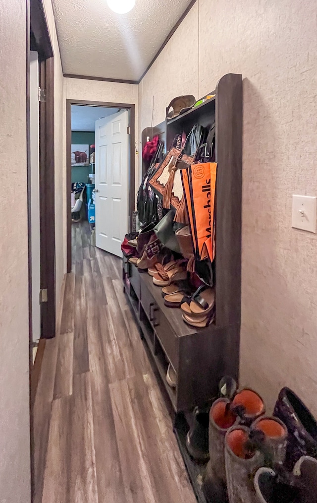 mudroom featuring wood-type flooring and a textured ceiling