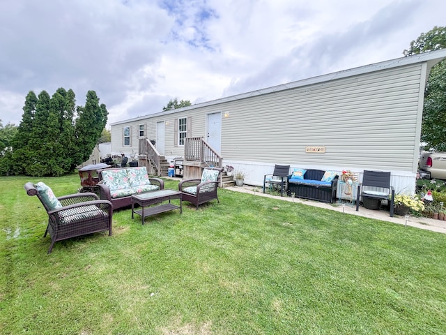 rear view of house featuring outdoor lounge area and a lawn