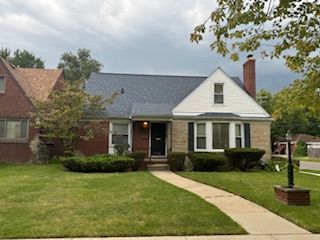 14257 Warwick St, Detroit, MI 48223 - view of front of home featuring a front lawn and a chimney