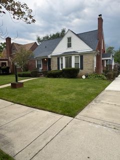 14257 Warwick St, Detroit, MI 48223 - view of front of property featuring a front yard and a chimney