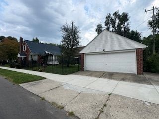 14257 Warwick St, Detroit, MI 48223 - view of side of home featuring an outdoor structure and a garage