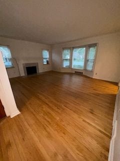14257 Warwick St, Detroit, MI 48223 - unfurnished living room with light wood finished floors and a fireplace