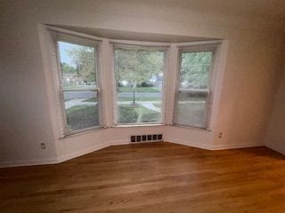 14257 Warwick St, Detroit, MI 48223 - empty room featuring baseboards, wood finished floors, and plenty of natural light