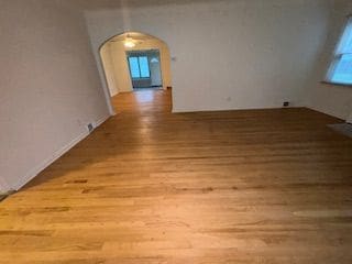 14257 Warwick St, Detroit, MI 48223 - empty room with wood finished floors and arched walkways