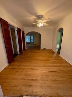 14257 Warwick St, Detroit, MI 48223 - hall with arched walkways, light wood-type flooring, and baseboards