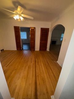 14257 Warwick St, Detroit, MI 48223 - unfurnished room featuring wood finished floors, arched walkways, and ceiling fan