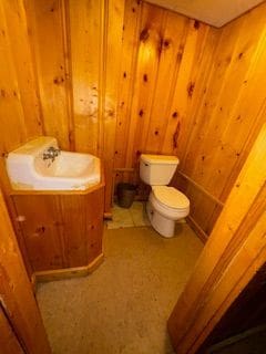 14257 Warwick St, Detroit, MI 48223 - half bath with toilet, wood walls, and vanity
