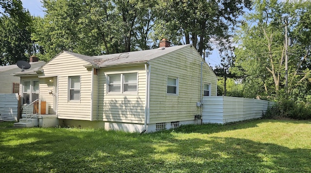 view of side of home featuring a lawn