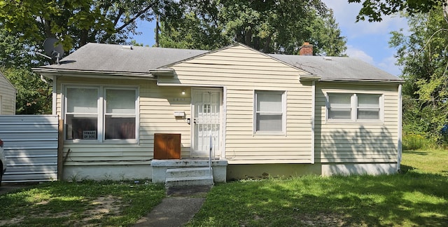 bungalow-style house featuring a front yard