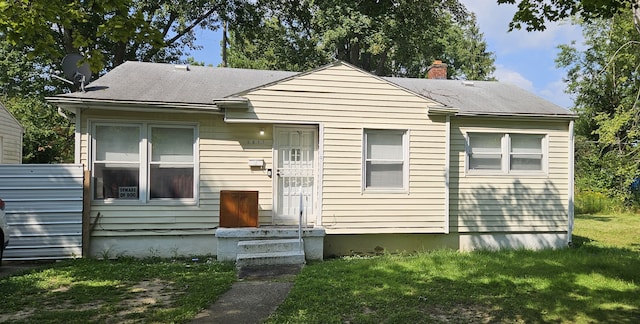 5817 Winthrop Blvd, Flint, MI 48505 - bungalow featuring a front yard, a chimney, and roof with shingles