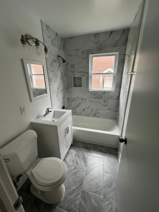 full bathroom with tiled shower / bath, vanity, a healthy amount of sunlight, and toilet