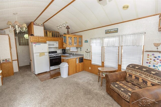978 Timberlynn Trl, Sanford, MI 48657 - kitchen with white appliances, a peninsula, a sink, vaulted ceiling, and carpet floors
