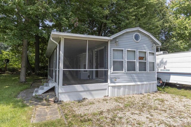 978 Timberlynn Trl, Sanford, MI 48657 - view of home's exterior featuring a sunroom