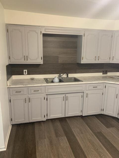 kitchen with white cabinets, dark hardwood / wood-style floors, and sink