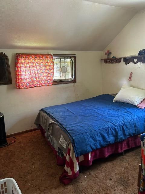 carpeted bedroom with vaulted ceiling