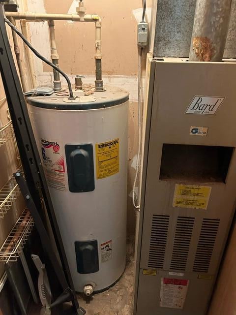 utility room with heating unit and water heater