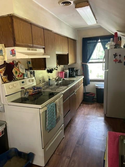 kitchen featuring white appliances, dark hardwood / wood-style floors, and sink