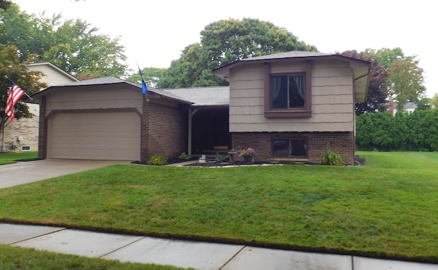 split level home with a front yard and a garage