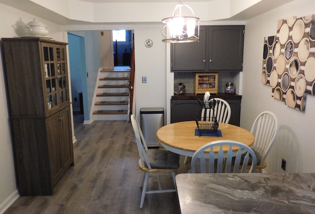 dining room featuring dark hardwood / wood-style flooring and a chandelier