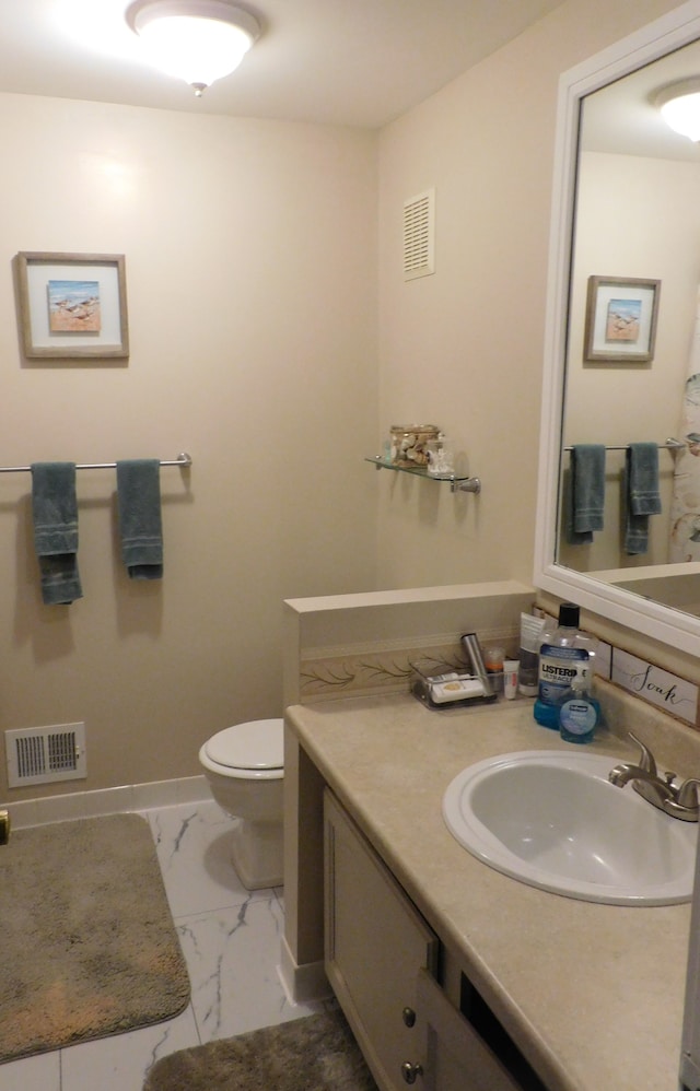 bathroom featuring vanity and toilet