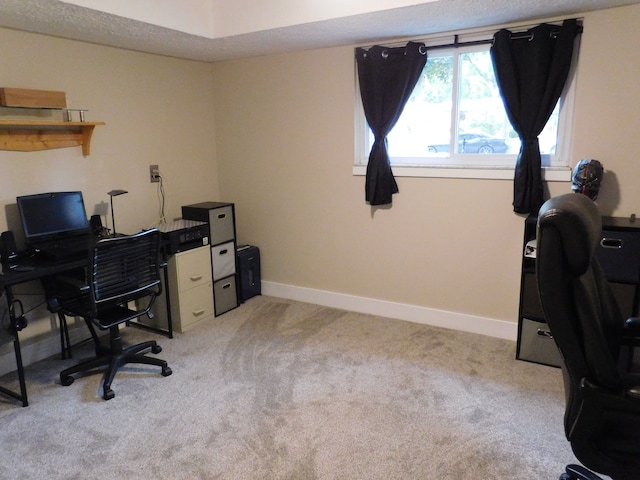 office with light colored carpet and a textured ceiling