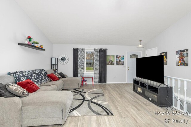 living room with lofted ceiling and light wood-type flooring