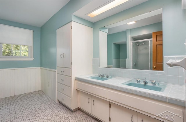 bathroom with vanity, backsplash, and walk in shower