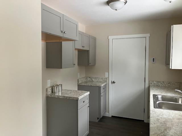 2711 Sawyer Rd, Traverse City, MI 49685 - kitchen featuring gray cabinets, dark hardwood / wood-style flooring, and sink