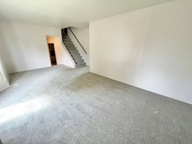 unfurnished living room featuring carpet