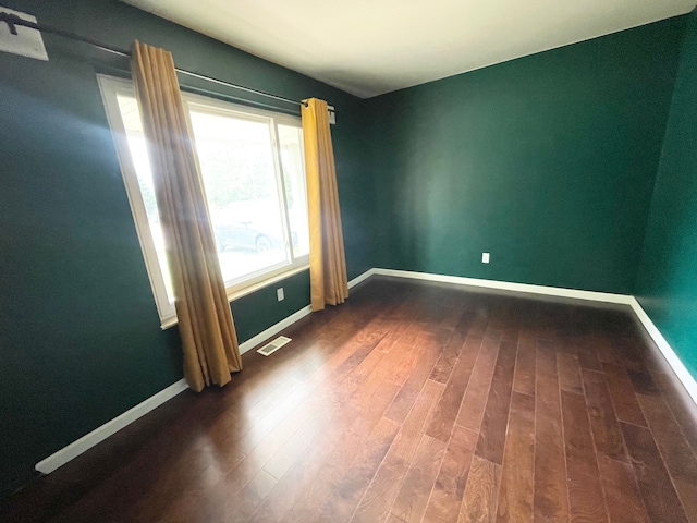 spare room featuring dark hardwood / wood-style floors