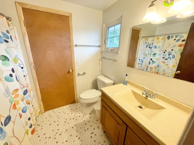 bathroom featuring tile patterned floors, vanity, and toilet