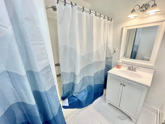 bathroom featuring vanity, toilet, and walk in shower