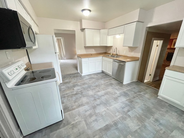 kitchen featuring white cabinets, sink, and appliances with stainless steel finishes