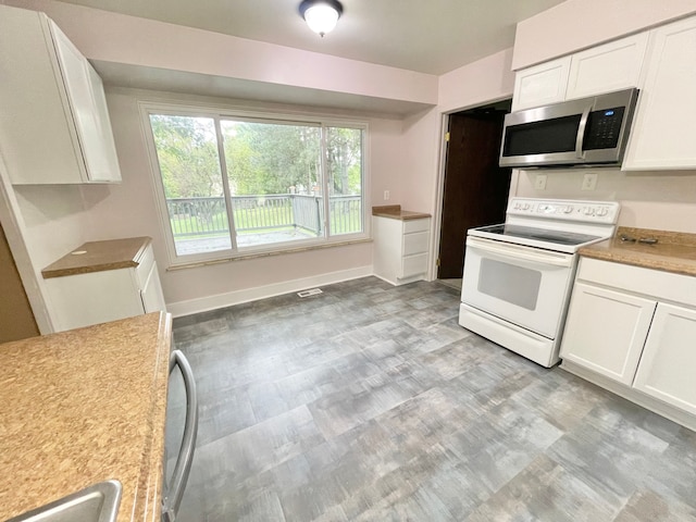 kitchen with white cabinetry and electric stove