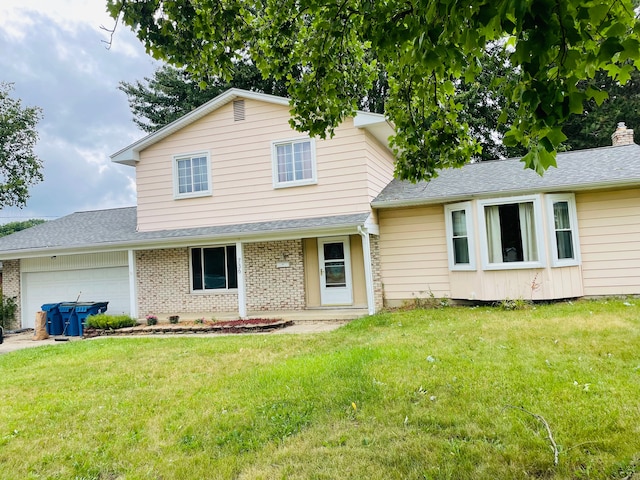 view of front of home featuring a garage and a front lawn