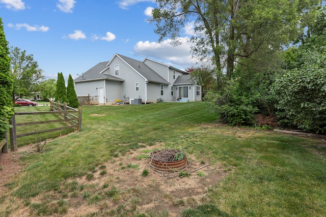 view of yard featuring a fire pit and cooling unit