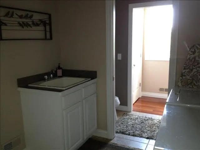 bathroom featuring hardwood / wood-style floors, vanity, and toilet