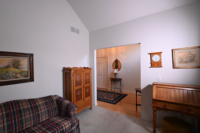 living room featuring light carpet and high vaulted ceiling