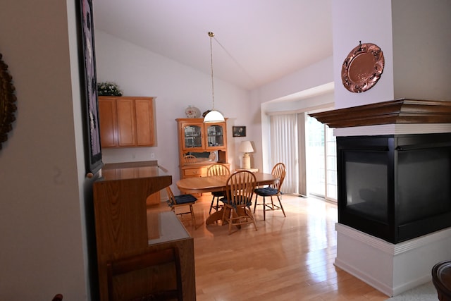 dining room with light hardwood / wood-style floors and lofted ceiling